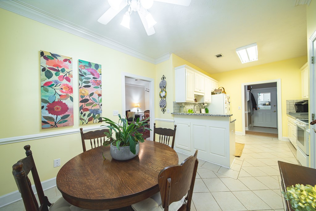 4607 Baltusrol Court Columbus, GA 31909 - Photo 11 of 35 a view of a dining room with furniture and a potted plant
