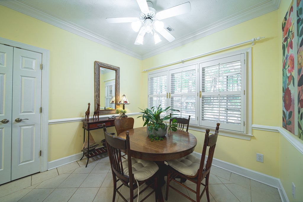 4607 Baltusrol Court Columbus, GA 31909 - Photo 12 of 35 a view of a dining room with furniture and a potted plant