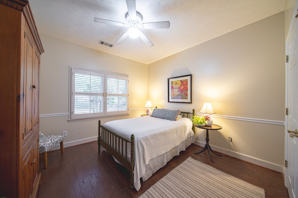 4607 Baltusrol Court Columbus, GA 31909 - Photo 18 of 35 a bedroom with a bed and a chandelier