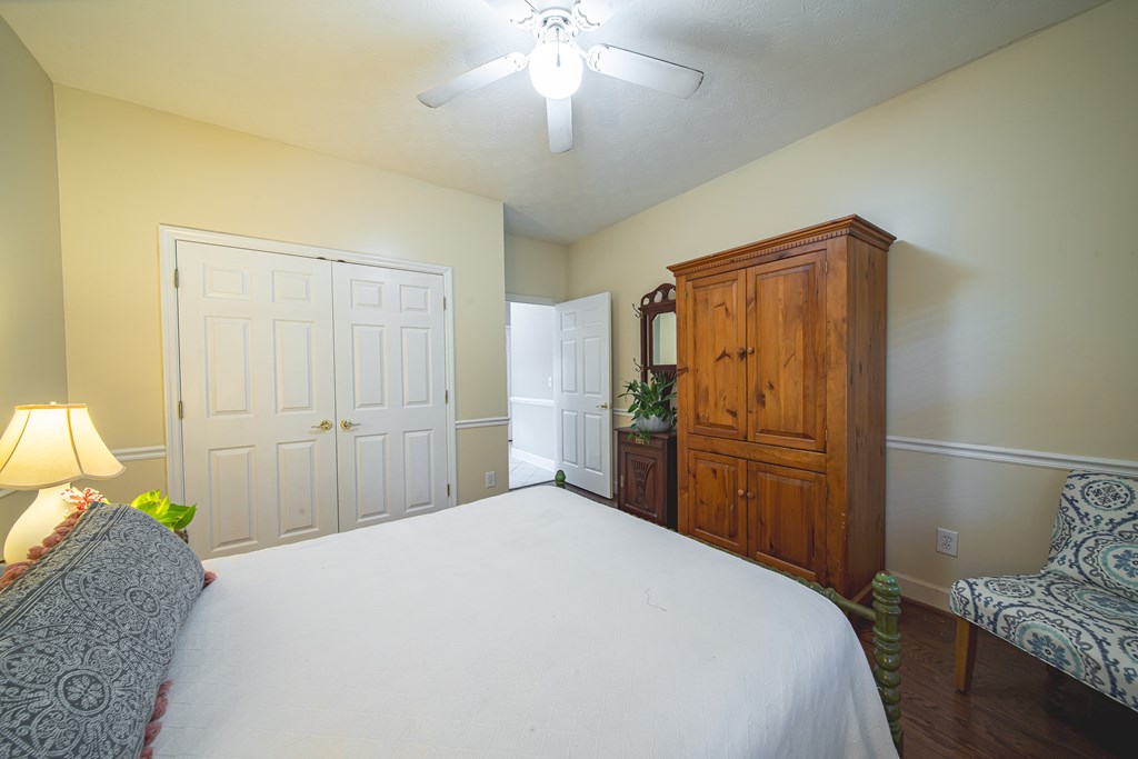 4607 Baltusrol Court Columbus, GA 31909 - Photo 19 of 35 a bedroom with a bed and a chandelier