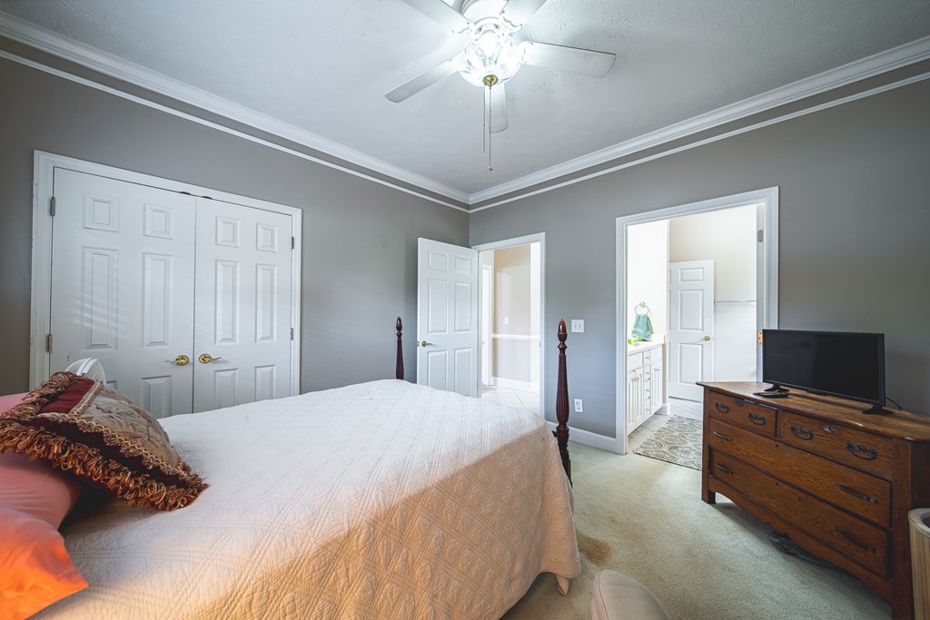 4607 Baltusrol Court Columbus, GA 31909 - Photo 20 of 35 a bedroom with a bed and a flat tv screen on dresser