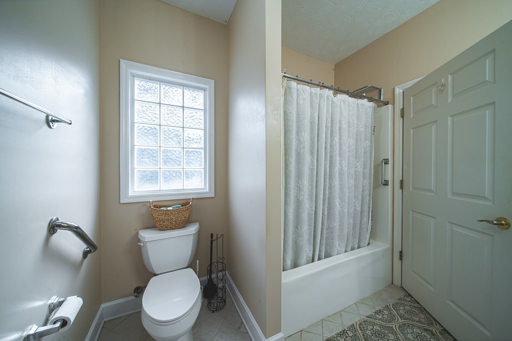 4607 Baltusrol Court Columbus, GA 31909 - Photo 22 of 35 a white toilet sitting next to a bathroom sink