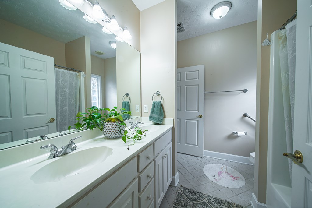 4607 Baltusrol Court Columbus, GA 31909 - Photo 23 of 35 a bathroom with a sink and mirror with toilet