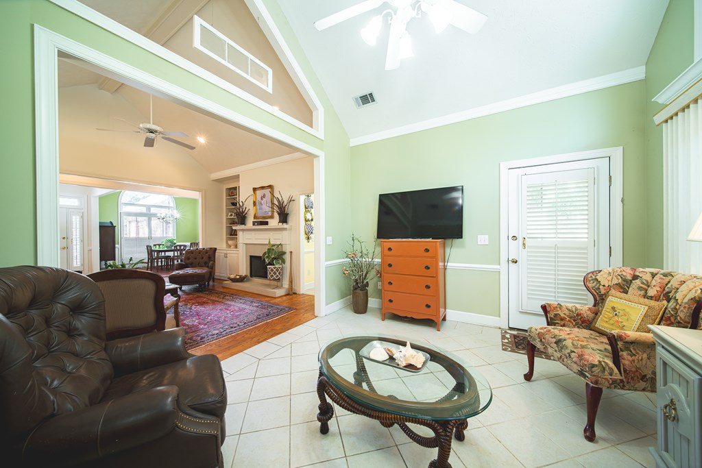 4607 Baltusrol Court Columbus, GA 31909 - Photo 7 of 35 a living room with furniture a flat screen tv and kitchen view