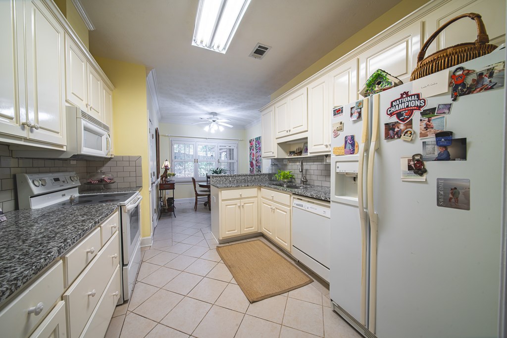 4607 Baltusrol Court Columbus, GA 31909 - Photo 10 of 35 a kitchen with stainless steel appliances granite countertop a refrigerator and a stove top oven