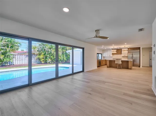 a view of a room with window and wooden floor