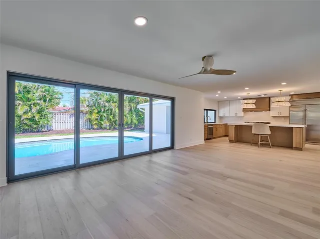a view of a kitchen with kitchen island a counter top space appliances and cabinets