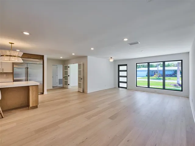a large kitchen with kitchen island a dining table and chairs