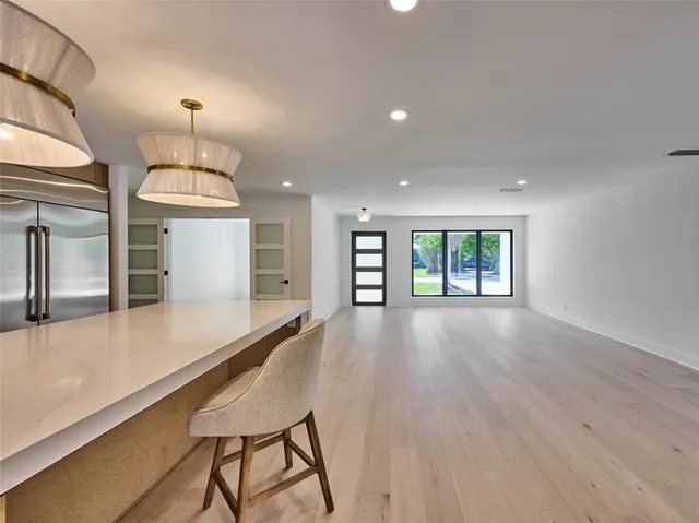 a kitchen with stainless steel appliances granite countertop a stove a sink and a wooden floors