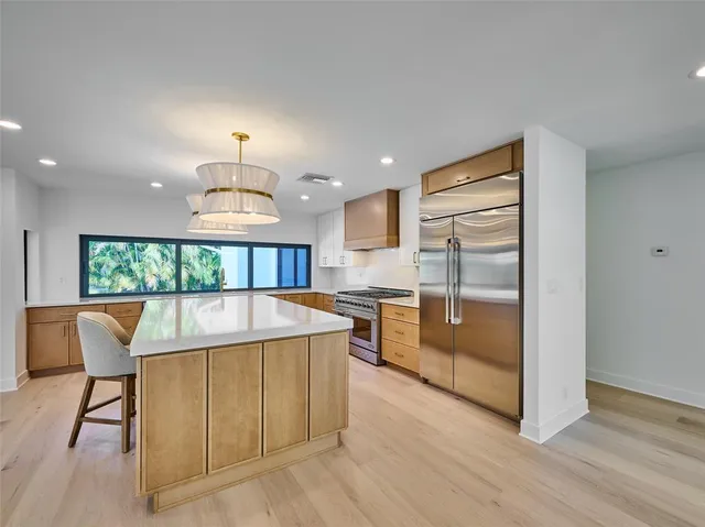 a kitchen with a stove and a wooden floors