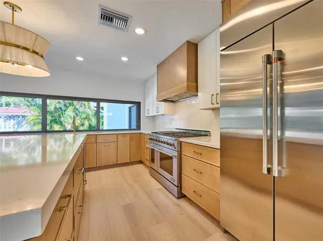a view of a kitchen with a sink and a refrigerator