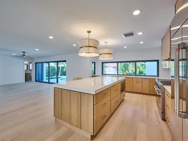 a view of a room with wooden floor and windows