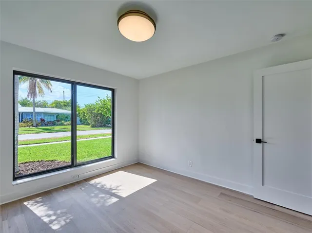 a bathroom with a sink mirror and a shower