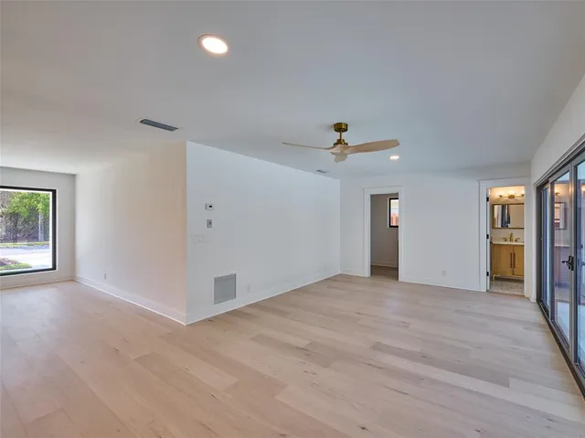 a bathroom with a sink mirror vanity and toilet
