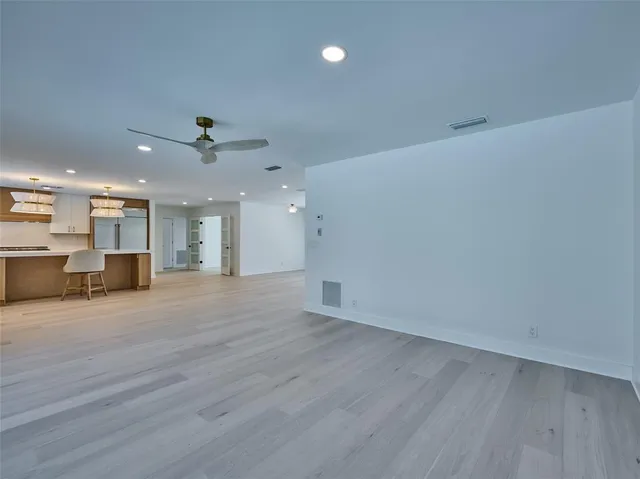 a view of a room with wooden floor and windows