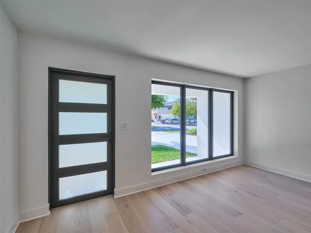 a view of empty room with fireplace and cabinet
