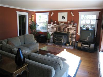 12995 Occidental Road Sebastopol, CA 95472 - Photo 2 of 12 Enter the front door and find yourself in this inviting living room with warm paint, custom mouldings, pellet stove, hardwood floors and wonderful light.