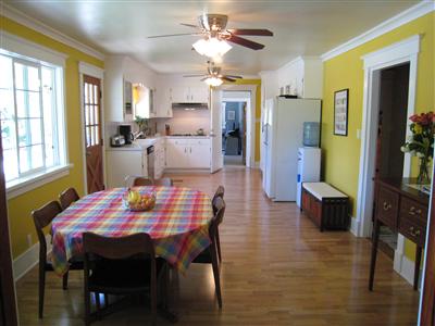 12995 Occidental Road Sebastopol, CA 95472 - Photo 3 of 12 Looking from the living room into the dining room and kitchen. Notice the gleaming hardwood floors, cheerful paint and soothing ceiling fans. Far door leads to bonus rooms and laundry/mud room.