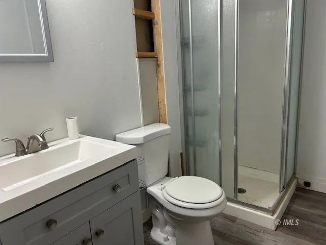 a backyard of a house with large trees and wooden fence