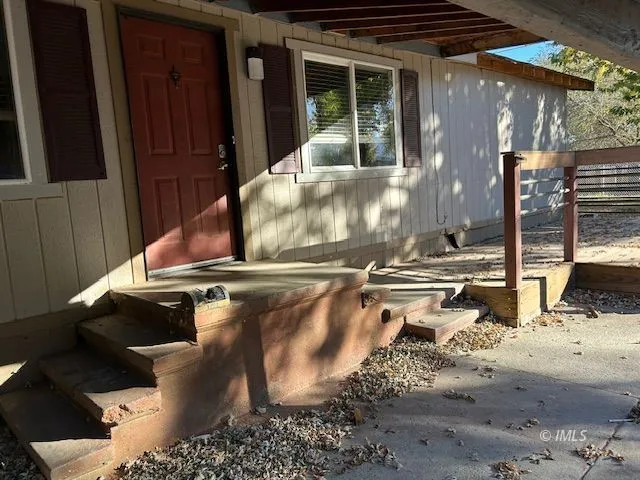 a view of a backyard with table and chairs and potted plants