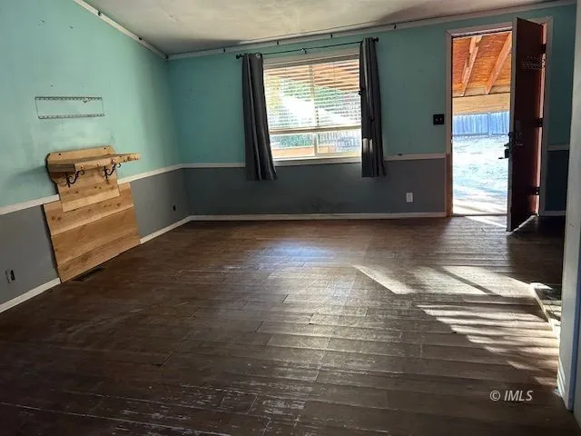 a view of a room with wooden floor and cabinet