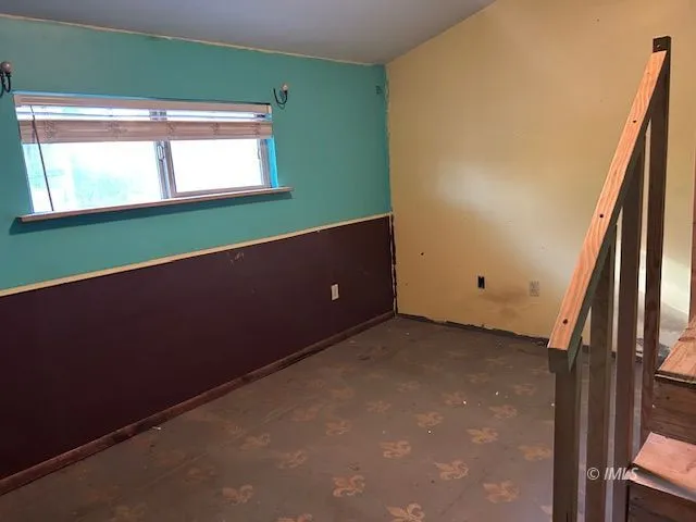 a view of a room with wooden floor and a bathroom