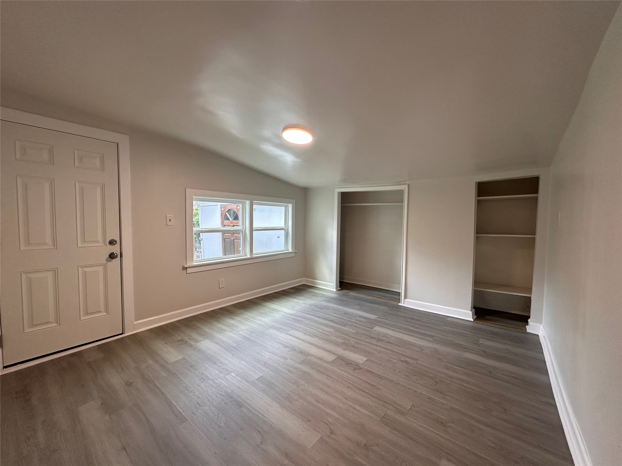 2516 Ivy Street Houston, TX 77026 - Photo 3 of 9 an empty room with wooden floor and windows