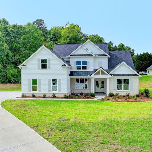 8875 Little Mill Road Cumming, GA 30041 - Photo 1 of 1 a front view of a house with a garden
