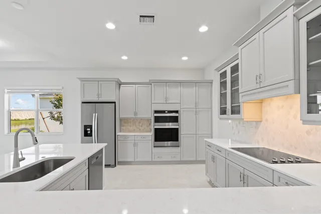 a kitchen with a sink stainless steel appliances and cabinets