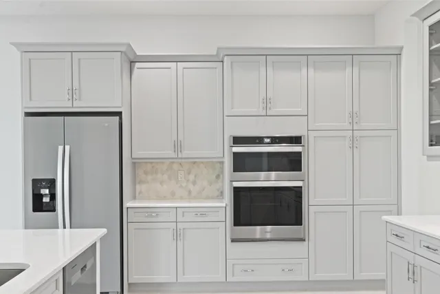 a kitchen with a sink window and cabinets