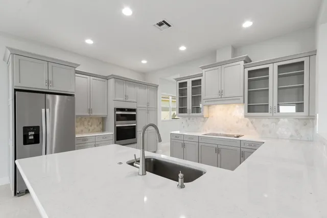 an empty room with windows and painted walls