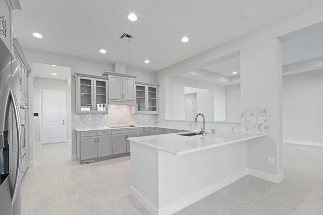 a view of an empty room with kitchen