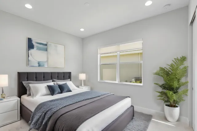 an aerial view of residential houses with outdoor space and trees