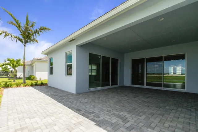 a view of a swimming pool with outdoor seating and plants