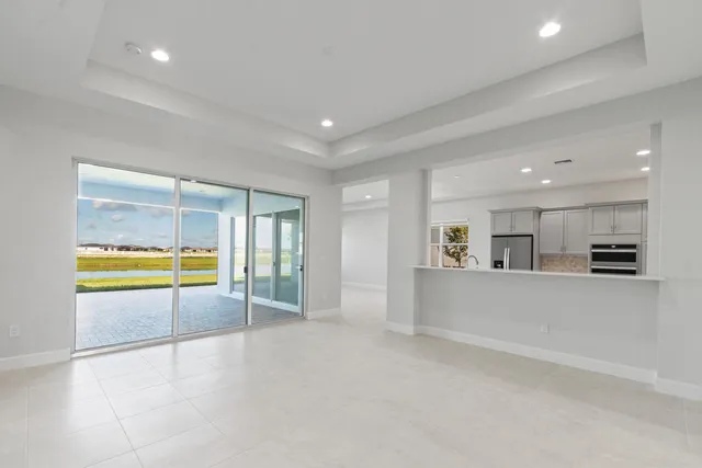 a kitchen with stainless steel appliances kitchen island granite countertop a sink and a refrigerator