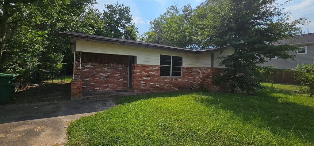 3610 Dennis Street Houston, TX 77004 - Photo 1 of 16 The front exterior showcases a classic brick façade, spacious front yard, and private driveway, providing convenient off-street parking.