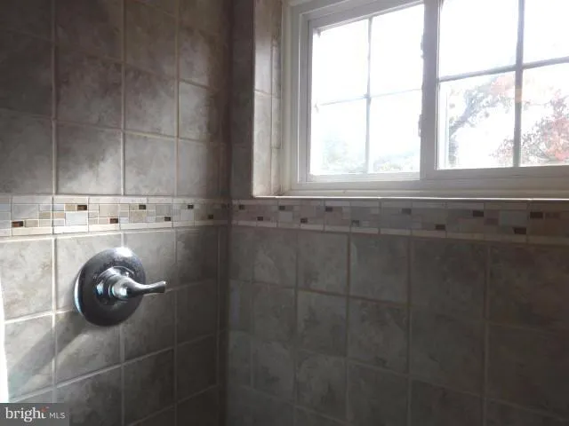 a white toilet sitting next to a bath tub