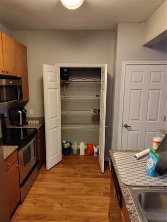 a kitchen with granite countertop a refrigerator and a stove