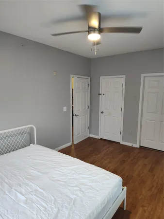 a bedroom with a bed and a chandelier