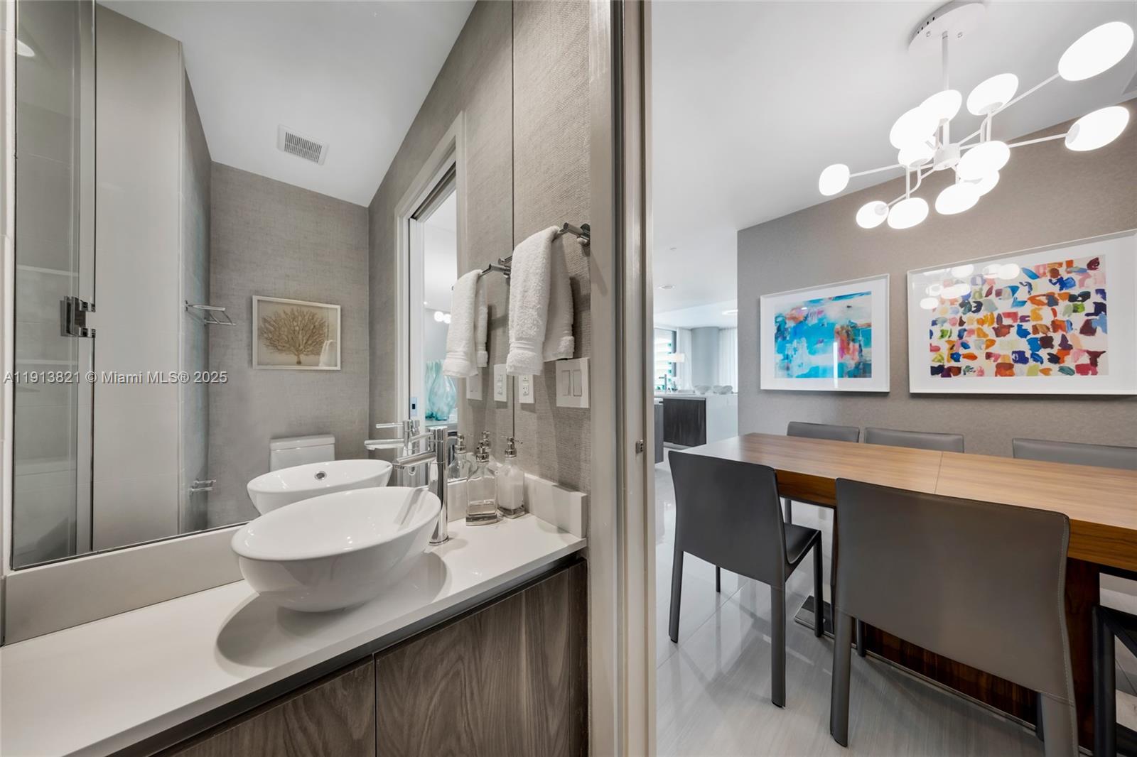 480 Northeast 31st Street, Unit 2807 Miami, FL 33137 - Photo 11 of 45 a bathroom with a sink a mirror and a bathtub