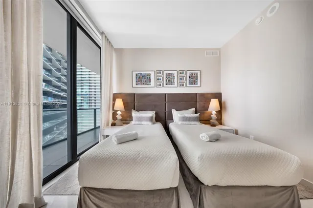 a bedroom with a bed and a night stand