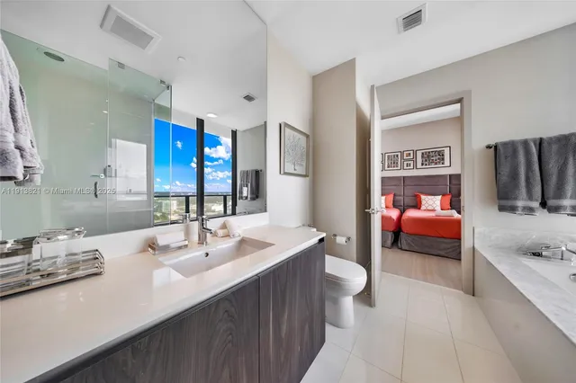 a en suite bathroom with a sink double vanity and a tub