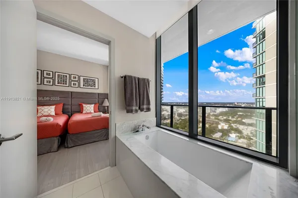 a bedroom with furniture and a window