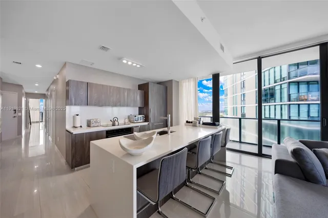 a kitchen with stainless steel appliances a sink stove and cabinets
