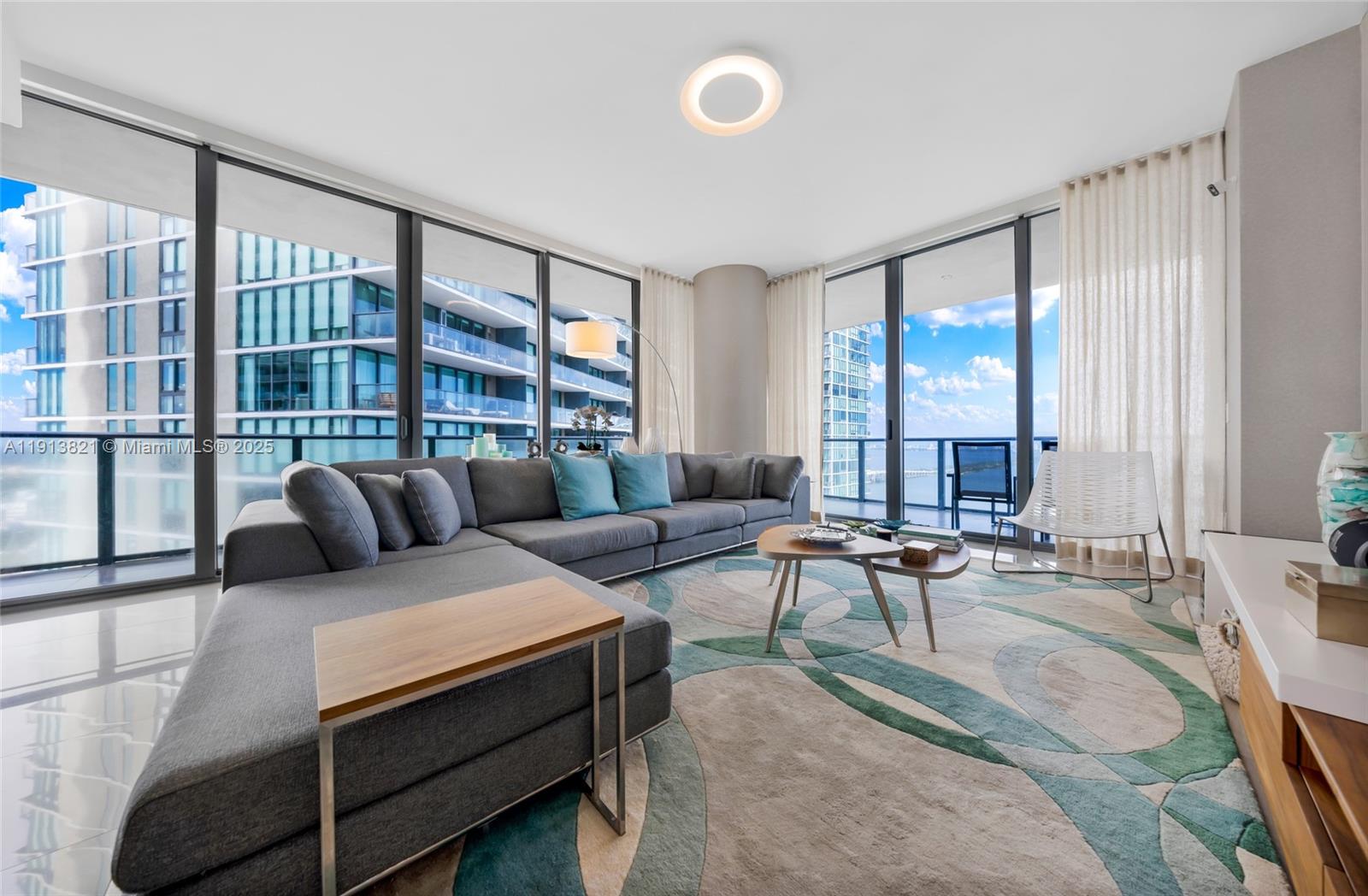 480 Northeast 31st Street, Unit 2807 Miami, FL 33137 - Photo 4 of 45 a living room with furniture and large windows