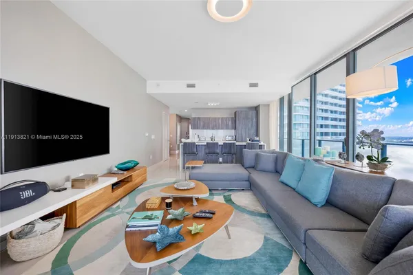 a living room with furniture and a flat screen tv