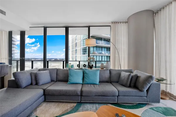 a living room with furniture and a large window