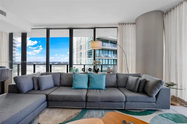 a living room with furniture and a large window