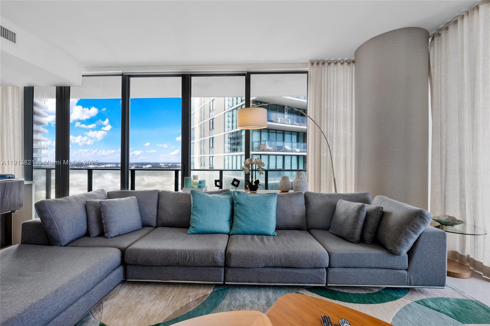 480 Northeast 31st Street, Unit 2807 Miami, FL 33137 - Photo 6 of 45 a living room with furniture and a large window