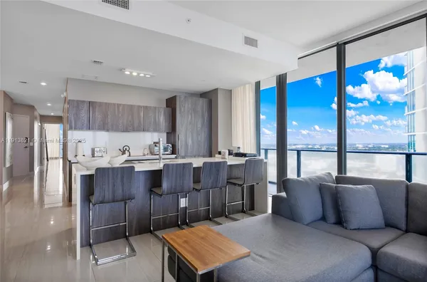 a living room with a couch and a dining table